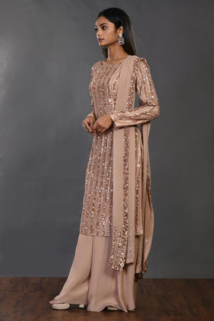 Shop beige embellished Mysore silk suit online in USA with dupatta. Dazzle on weddings and special occasions with exquisite Indian designer dresses, sharara suits, Anarkali suits, wedding lehengas from Pure Elegance Indian fashion store in USA.-side