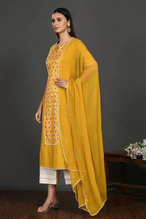 Shop yellow stone and pearl work chanderi suit online in USA with dupatta. Dazzle on weddings and special occasions with exquisite Indian designer dresses, sharara suits, Anarkali suits, wedding lehengas from Pure Elegance Indian fashion store in USA.-dupatta