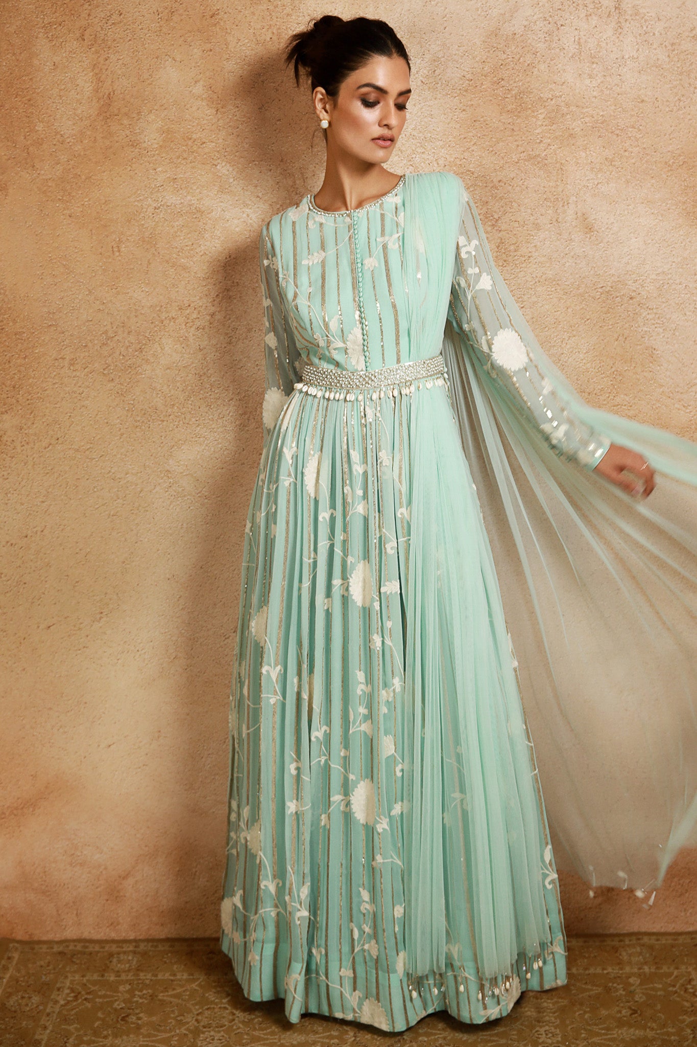 Shop this look your best on festive occasions in this stunning aqua-blue floral georgette Anarkali suit. It comes with an embroidered belt and a matching attached dupatta. Shop online from Pure Elegance- Front View