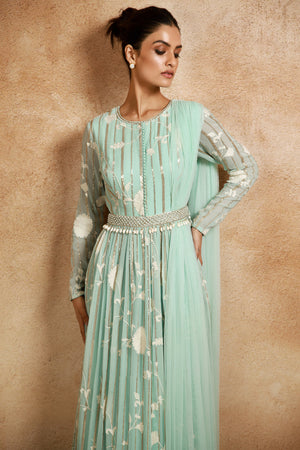 Shop this look your best on festive occasions in this stunning aqua-blue floral georgette Anarkali suit. It comes with an embroidered belt and a matching attached dupatta. Shop online from Pure Elegance