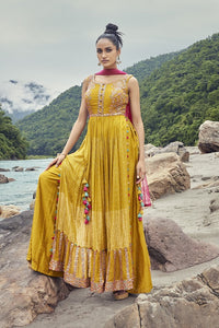 Shop by the cynosure of all eyes as you flaunt this set of yellow naira cut style kurta and sharara from Pure Elegance. Complete the look by wearing statement jewelry and heels. Wear yours with statement earrings and metallic flats.
