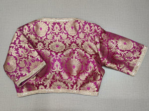 Buy exquisite pink color with the golden design. This blouse is great to buy. Pair this fashionable blouse with beautiful silk sarees and a statement neckpiece and you're good to go!  Elevate your Indian saree style with exquisite readymade sari blouse, embroidered saree blouses, Banarasi sari blouse, and designer sari blouse from Pure Elegance Indian clothing store in USA.- Back View
