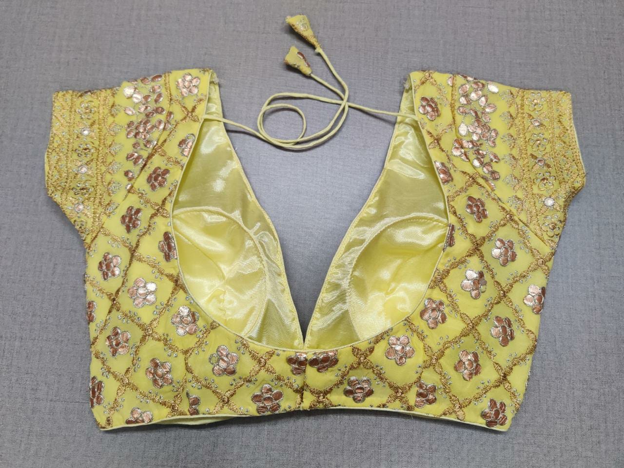 Buy this yellow color beautiful sequin designer blouse from Pure Elegance. A perfect go-to combination for your contemporary yet ethnic look. Elevate your Indian saree style with exquisite readymade sari blouse, embroidered saree blouses, Banarasi sari blouse, and designer sari blouse from Pure Elegance Indian clothing store in USA.- Back View