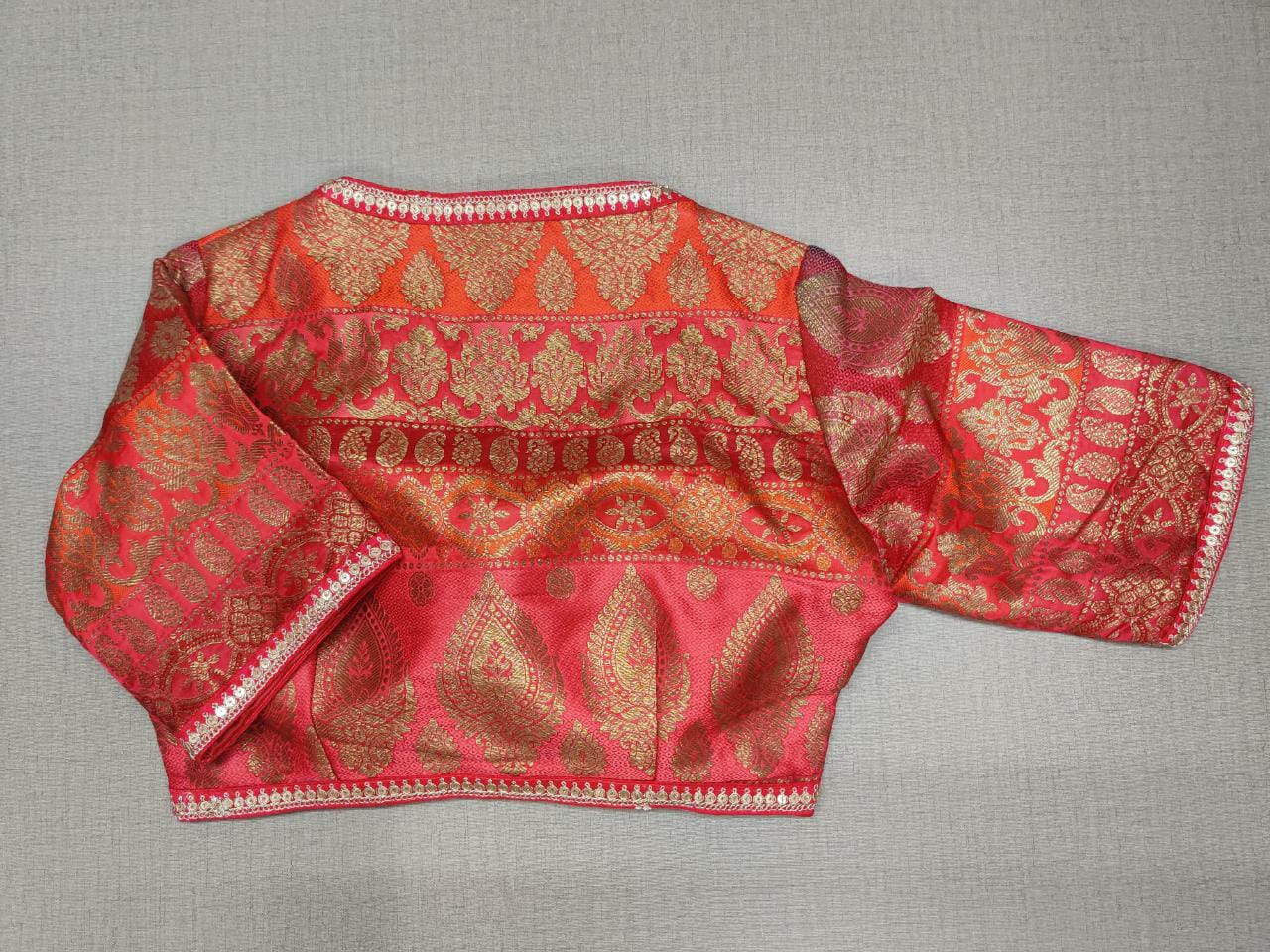Buy a red embellished zari designer saree blouse that has a U-neck and tie-up details. This saree blouse is both comfortable and elegant. Style it with a traditional silk saree, chanderi sarees, crepe sarees with statement jewelry, and heels for a classy look. . Elevate your Indian ethnic sarees with beautiful readymade sari blouses, embroidered saree blouses, Banarasi saree blouses, designer sari blouses, and choli-cut blouses from Pure Elegance Indian fashion store in USA.-Back View
