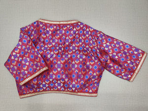 Buy this exquisite pink color with a blue design. This blouse is great to buy. Pair this fashionable blouse with beautiful silk sarees and a statement neckpiece and you're good to go!  Elevate your Indian saree style with exquisite readymade sari blouse, embroidered saree blouses, Banarasi sari blouse, and designer sari blouse from Pure Elegance Indian clothing store in USA.-Back View