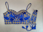 Buy exquisite dark blue color with golden embroidery work designer. It has a strappy blouse with a sweetheart front. Pair it with a contrasting saree to make your look more graceful.. Elevate your Indian saree style with exquisite readymade sari blouse, embroidered saree blouses, Banarasi sari blouse, and designer sari blouse from Pure Elegance Indian clothing store in the USA.- Front View