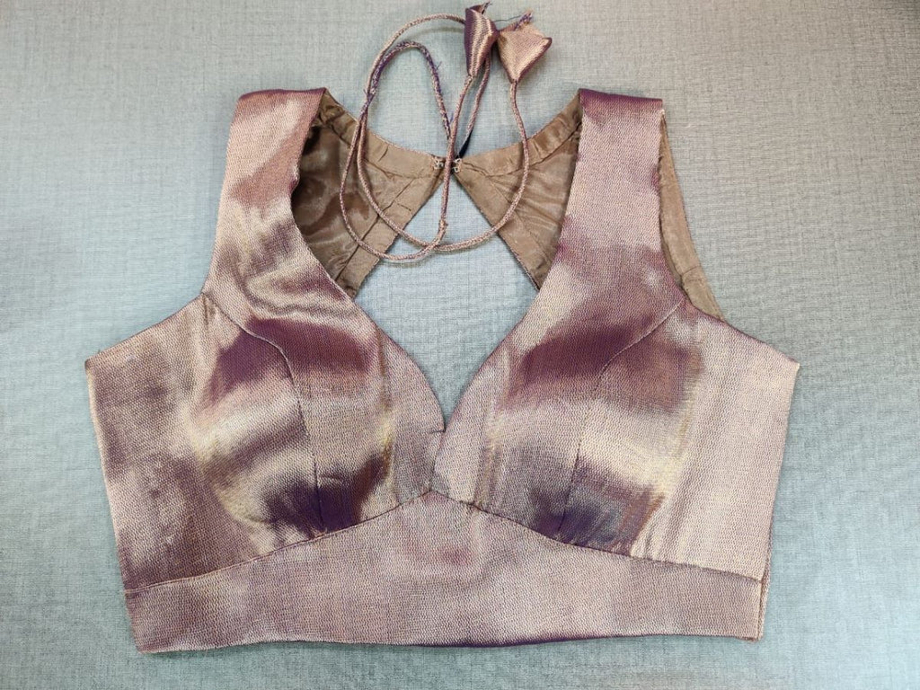 Buy a tailored blouse in a timeless hue and topped with elegant details, this copper blouse is an evergreen addition to your festive wardrobe and party look. It is designed with a V neckline, sleeveless, and back hook closure with a tie-up. Buy this designer blouse in the USA from Pure Elegance. - Front View