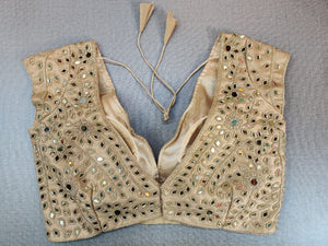 Buy exquisite beige color mirror work designer. It has a V back and tassels to tie up. Pairs it with a contrasting saree to make your look more graceful. . Elevate your Indian saree style with exquisite readymade sari blouse, embroidered saree blouses, Banarasi sari blouse, designer sari blouse from Pure Elegance Indian clothing store in USA.- Back View