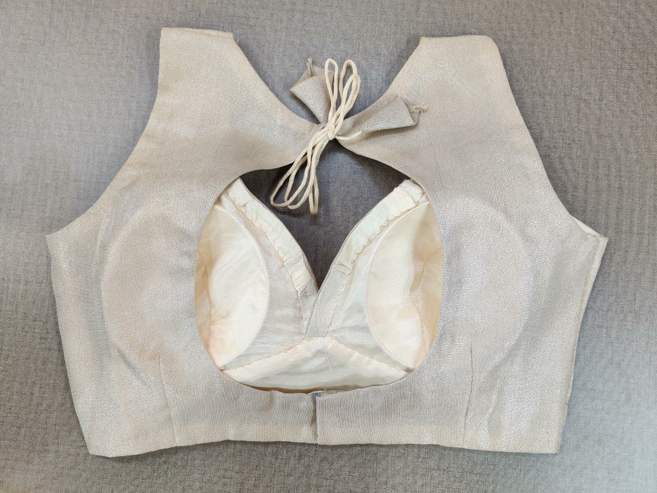 Buy and indulge yourself in the blooming charm of summer with this silver blouse. Featuring a beautiful back with hook closure and tie-up, this blouse is the perfect night-occasion and day-occasion add-on. Elevate your Indian saree style with exquisite readymade sari blouse, embroidered saree blouses, Banarasi sari blouse, and designer sari blouse from Pure Elegance Indian clothing store in the USA.- Back View