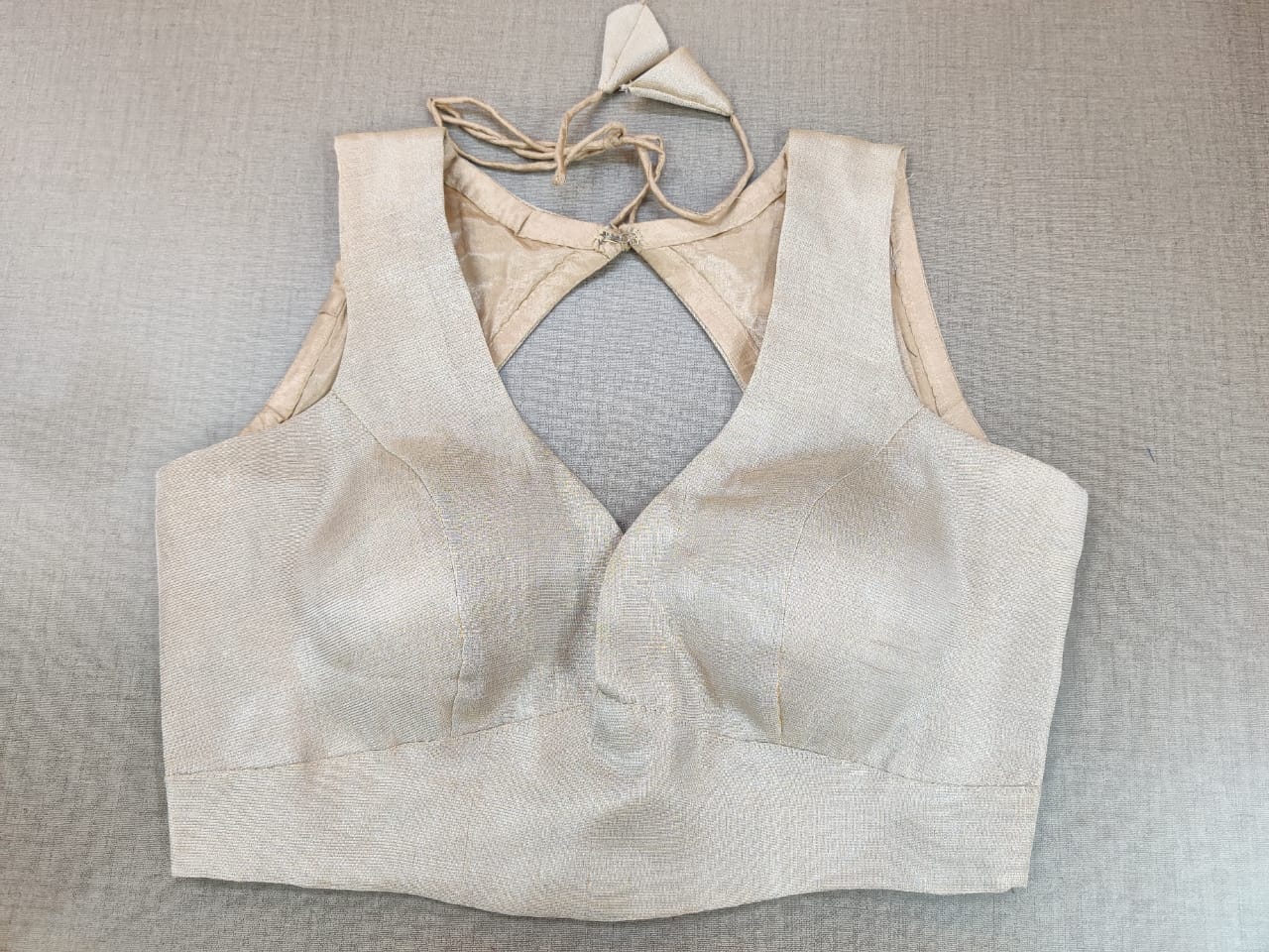 Buy and indulge yourself in the blooming charm of summer with this silver blouse. Featuring a beautiful back with hook closure and tie-up, this blouse is the perfect night-occasion and day-occasion add-on. Elevate your Indian saree style with exquisite readymade sari blouse, embroidered saree blouses, Banarasi sari blouse, and designer sari blouse from Pure Elegance Indian clothing store in the USA.- Front View