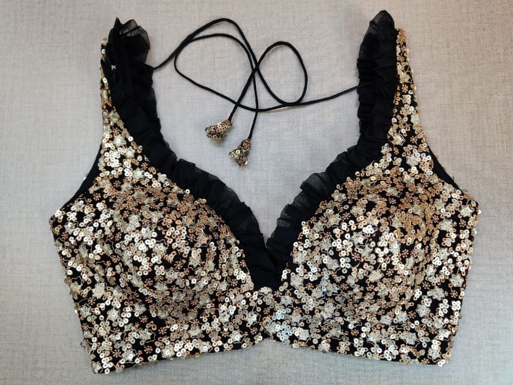 Buy a black blouse crafted in hammered silk With beautiful sequinned work. Tailored with strappy shoulders, the blouse features a smocked back for comfort and style, and a tie-up closure. Give your ethnic look a dazzling update with this pink blouse. Buy this designer blouse in USA from Pure Elegance. - Front View