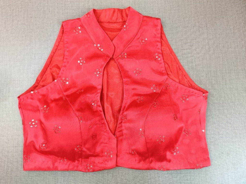 Shop stunning red readymade blouse from surely fetch you compliments for your rich sense of style. The red blouse with sequin embroidery details has a mandarin collar, a sleeveless, and a hook closure at the front. Complement your look with statement jewelry and high heels to complete the ensemble. Buy this designer blouse in the USA from Pure Elegance.  - Front View