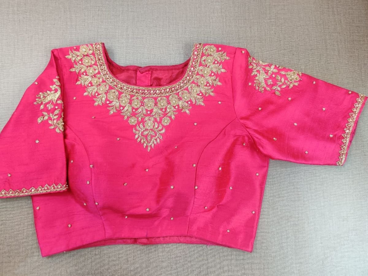 Buy Classic is never old and enough to have in your closet!! This blouse compliments a beautiful embroidery on the neck and hooks closure at the back. Pair this fashionable pink blouse with a beautifully printed sari and statement earrings and you are good to go! Elevate your Indian saree style with exquisite readymade sari blouse, embroidered saree blouses, Banarasi sari blouse, and designer sari blouse from Pure Elegance Indian clothing store in the USA.- Front View