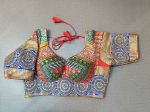 Buy a Multi-Color blouse crafted in hammered silk with beautiful embroidery work. Tailored with short sleeves, the blouse features a smocked back for comfort and style, and a tie-up closure. Give your ethnic look a dazzling update with this multi-color blouse. Buy this designer blouse in the USA from Pure Elegance. - Front View