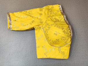 Buy classic is never old and enough to have in your closet!! This blouse compliments a beautiful Zari embroidery, V neck, and hooks closure at the back. Pair this fashionable yellow blouse with beautiful statement earrings and you are good to go! Elevate your Indian saree style with exquisite readymade sari blouse, embroidered saree blouses, Banarasi sari blouse, and designer sari blouse from Pure Elegance Indian clothing store in the USA.- Folded View