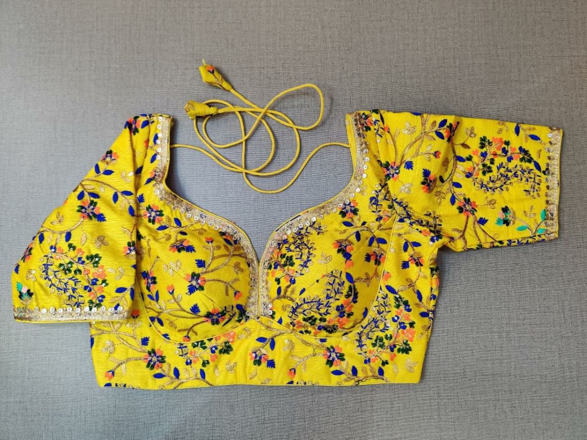 Buy a yellow silk saree blouse that has a sweetheart neck, 3/4th sleeves, and hook closure. Yellow blouse crafted in hammered silk with beautiful floral embroidery work. This charming blouse surely fetches you compliments for your rich sense of style. Complement your look with statement jewelry and high heels to complete the ensemble.- Front View