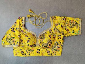 Buy a yellow silk saree blouse that has a sweetheart neck, 3/4th sleeves, and hook closure. Yellow blouse crafted in hammered silk with beautiful floral embroidery work. This charming blouse surely fetches you compliments for your rich sense of style. Complement your look with statement jewelry and high heels to complete the ensemble.- Front View