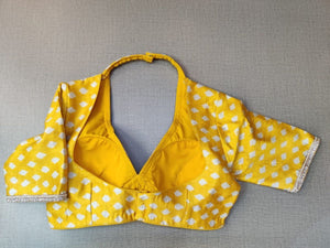 Buy this look in the gaiety of spring with this enchanting yellow blouse. Tailored in silk, it features a white polka dot print and neck embroidery and gets its finishing touches with hook closure at the back. Perfect blouse for Haldi functions. Elevate your Indian saree style with exquisite readymade sari blouse, embroidered saree blouses, Banarasi sari blouse, and designer sari blouse from Pure Elegance Indian clothing store in the USA.- Back View