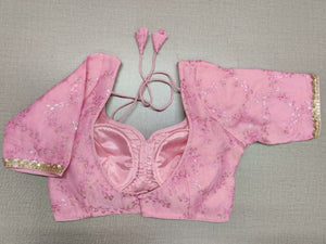 Buy a pink blouse crafted in hammered silk with beautiful embroidery work. Tailored with short sleeves, the blouse features a smocked back for comfort and style, and a tie-up closure. Give your ethnic look a dazzling update with this multi-color blouse. Buy this designer blouse in the USA from Pure Elegance. - Back View