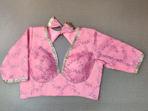 Buy a pink blouse crafted in hammered silk with beautiful embroidery work. Tailored with short sleeves, the blouse features a smocked back for comfort and style, and a tie-up closure. Give your ethnic look a dazzling update with this multi-color blouse. Buy this designer blouse in the USA from Pure Elegance. - Front View