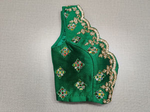 Buy exquisite green color mirror work designer. It has a beautiful V-neck and hooks closure. Pairs it with a contrasting saree to make your look more graceful. Perfect blouse for cocktail parties. Elevate your Indian saree style with exquisite readymade sari blouse, embroidered saree blouses, Banarasi sari blouse, and designer sari blouse from Pure Elegance Indian clothing store in the USA.- Folded View