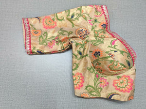 Buy a beautiful beige color Indian saree designer blouse with floral print. You can pair up with any Indian Saree for any occasion to make your look elegant. A beige multicolor floral blouse is a woven design padded saree blouse that has a V neck,  a beautiful back, and hook closure. You can pair it with any Indian Saree, Banarasi Silk Sarees, and Chanderi Silk sarees. Buy it from Pure Elegance sari blouse from Pure Elegance Indian clothing store in the USA.- Folded View