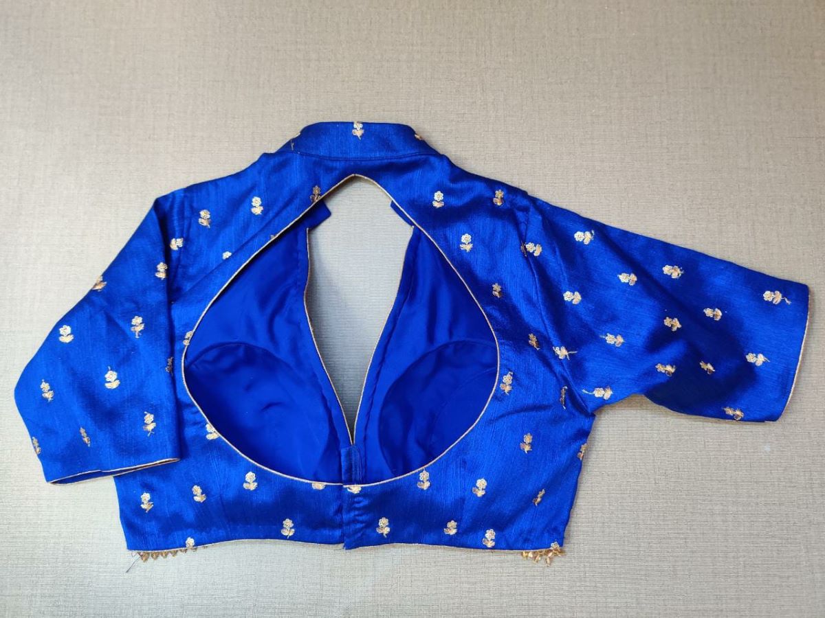 Buy a dark blue silk saree blouse that has a shirt collar neck, three-quarter sleeves, and hook closure. Blue blouse crafted in hammered silk with beautiful embroidery work. This charming blouse surely fetches you compliments for your rich sense of style. Complement your look with statement jewelry and high heels to complete the ensemble. Buy this designer blouse in the USA from Pure Elegance. - Back View