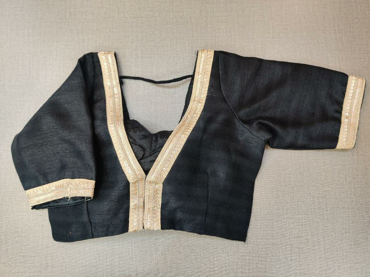 Buy a beautiful black color Indian saree designer blouse with embroidery. You can pair up with any Indian Saree for any occasion to make your look elegant. A black blouse is a woven design padded saree blouse that has a V neck,  a beautiful back, and hook closure. You can pair it with any Indian Saree, Banarasi Silk Sarees, and Chanderi Silk sarees. Buy it from Pure Elegance sari blouse from Pure Elegance Indian clothing store in the USA.- Back View