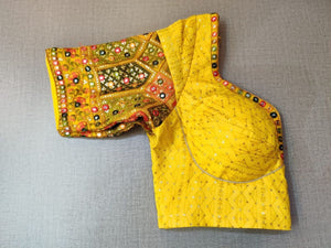 Buy this saree blouse looks graceful and elegant and is extremely comfortable. Yellow woven design padded saree blouse has a U neck, hook closure at back, tie-up detail at the back, and short sleeves style it with a pretty saree or skirt, statement jewelry, and heels to look your best. Elevate your Indian saree style with exquisite readymade sari blouse, embroidered saree blouses, Banarasi sari blouse, and designer sari blouse from Pure Elegance Indian clothing store in the USA.- folded View