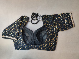 Buy this blouse to righten up your festive nights with this enchanting black sequin embroidered sleeveless blouse. Featuring sequin embroidery on the blouse, U shape front & back,hook closure and tie up . This blouse can elevate the simplest of outfits. Buy this designer blouse in the USA from Pure Elegance. - Back View