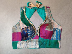 Buy a turquoise multicolor printed padded saree blouse, that has a V-neck, short sleeves, tie-up detail at the back, hook, and eye closure. Let your aura shine throughout by wearing this designer saree blouse. Pair this fashionable blouse with a beautiful printed sari and statement neck piece and you are good to go.- Front View
