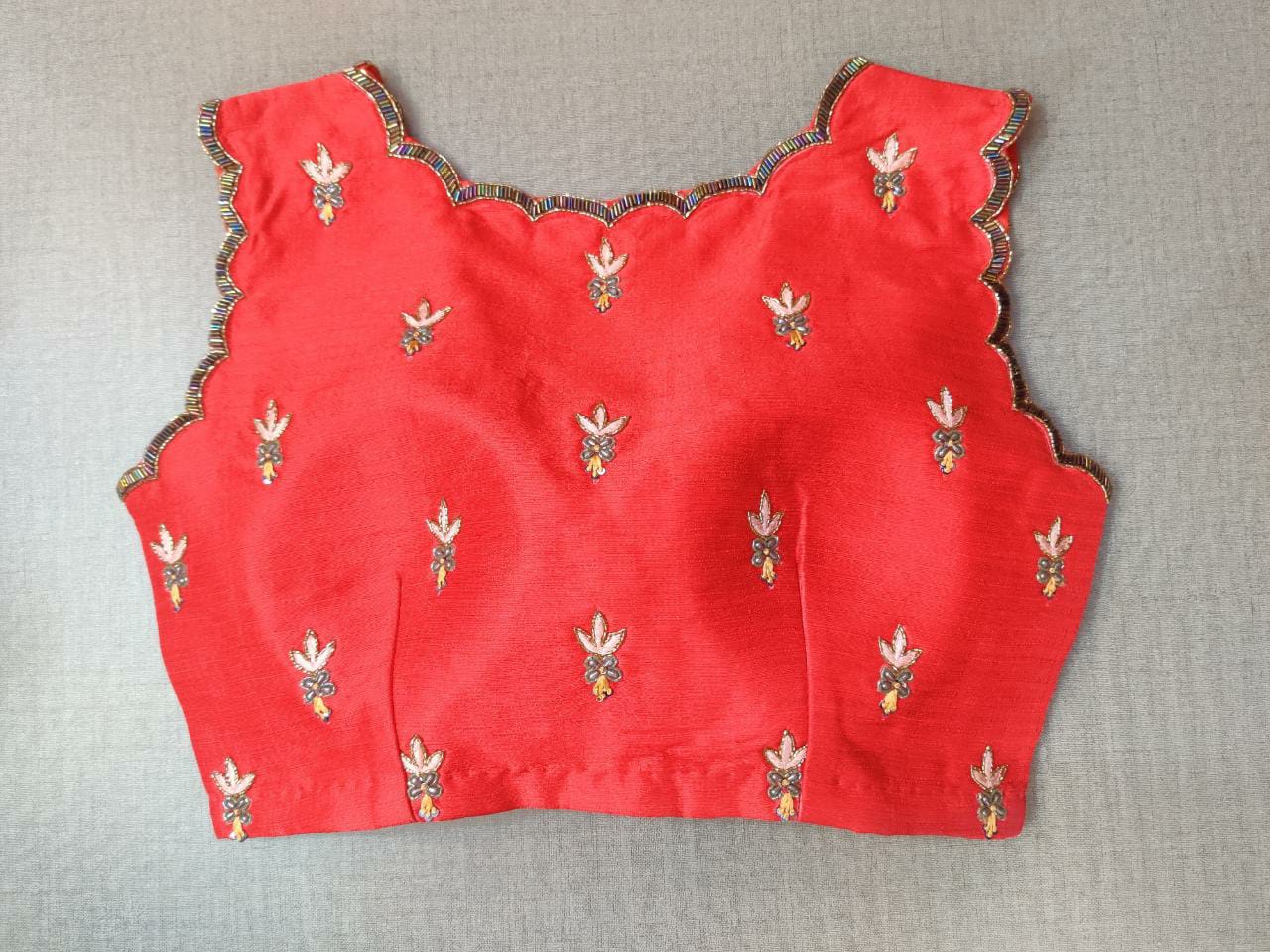 Buy this festive essential and get an elevated twist with this red floral embroidered blouse. Featuring an embroidered front & back, the blouse is cut with a tulip hem, V-neck, and sleeveless. Wear it with a contrasting saree or even with a contrasting lehenga skirt to complete the look. Elevate your Indian saree style with exquisite readymade sari blouses, embroidered saree blouses, Banarasi sari blouses, and designer sari blouses from Pure Elegance Indian clothing store in the USA.- Back View