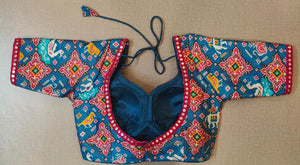 Buy the Blue & red block-printed saree blouse, which has an elephant print, U-neck with mirror work, short sleeves with mirror work, a tie-up at the back, and hook closures. This saree blouse looks graceful and elegant and is extremely comfortable. Style it with a pretty saree or skirt, statement jewelry, and heels to look your best.- Front View- Back View