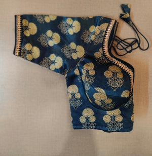 Buy classic design and soft charming hue, this navy floral patch blouse makes for an all-year festive must-have. Featuring a floral print, the blouse is cut with a U-neck and elbow-length sleeves, hook & tie-up closure. Elevate your Indian saree style with exquisite readymade sari blouses, embroidered saree blouses, Banarasi sari blouses, and designer sari blouses from Pure Elegance Indian clothing store in the USA.- Folded View