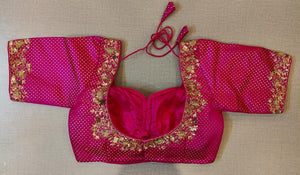 Buy the pink print saree blouse that has a U-neck with embroidery, short sleeves with embroidery, a tie-up at the back, and hook closures. .- Back View