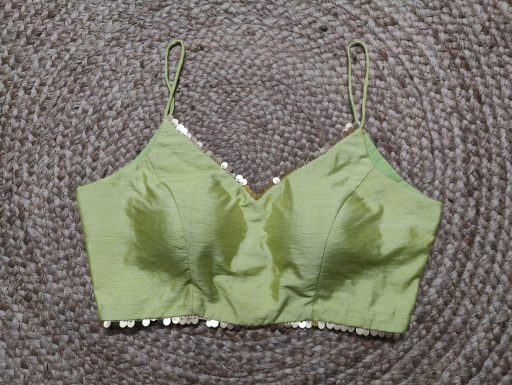 Dress to the nines in this subtly pastel green strappy blouse. Featuring a sequin embroidery, this top is the easiest way to glam up a solid silhouette. Pair it with Indian silk designer sarees. Buy this designer blouse in USA from Pure Elegance. - Front View