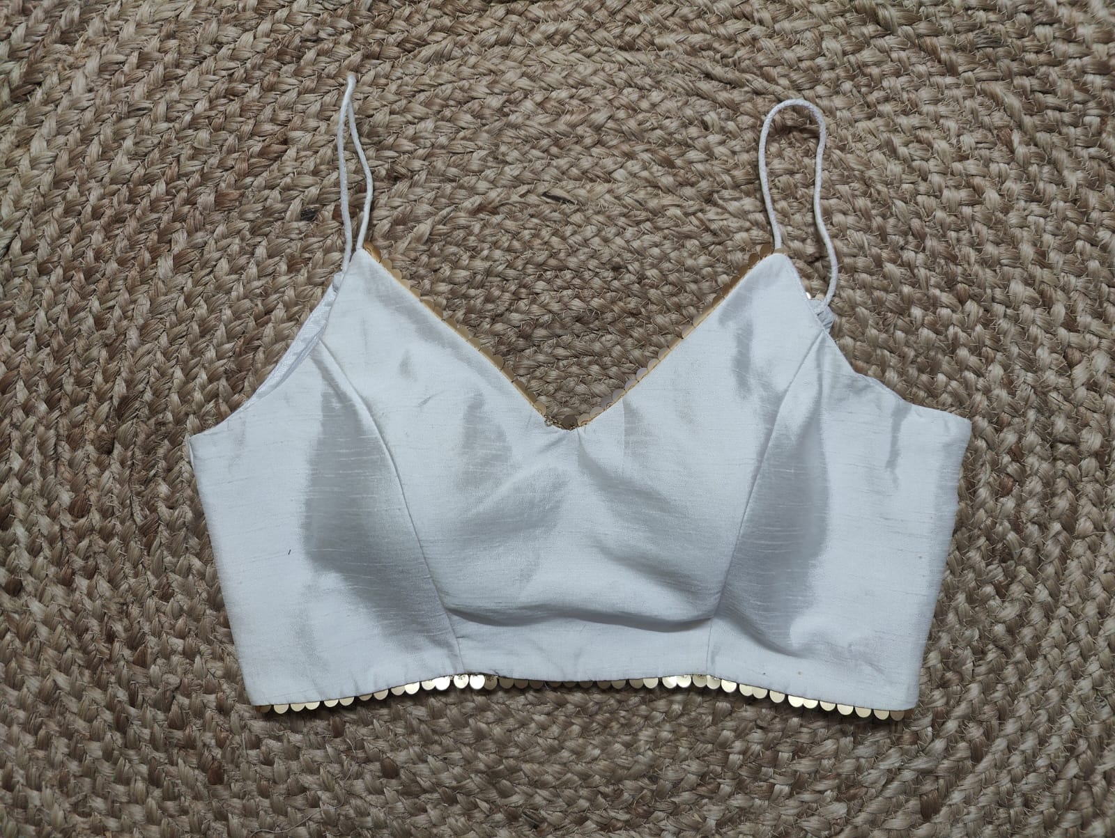 Solid white blouse crafted in hammered silk. Tailored with strappy shoulders, the blouse features a smocked back for comfort and style, and a zip closure. Give your ethnic look a dazzling update with this white silk blouse. Buy this designer blouse in USA from Pure Elegance. -Front View