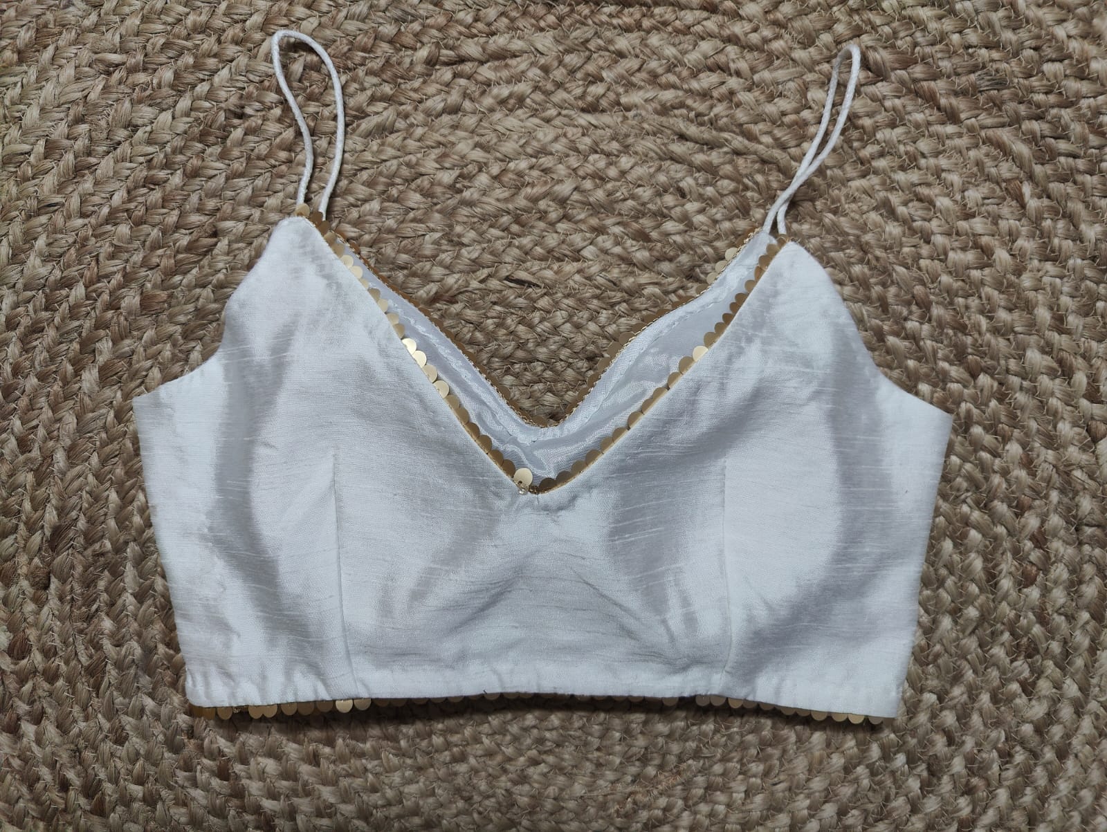 Solid white blouse crafted in hammered silk. Tailored with strappy shoulders, the blouse features a smocked back for comfort and style, and a zip closure. Give your ethnic look a dazzling update with this white silk blouse. Buy this designer blouse in USA from Pure Elegance. -Back View