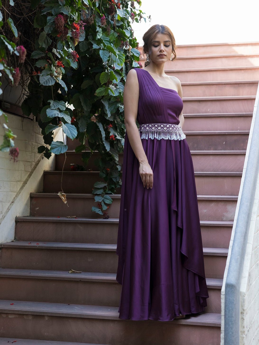 Buy stunning purple georgette one shoulder gown online in USA. Dazzle on weddings and special occasions with exquisite Indian designer dresses, sharara suits, Anarkali suits, wedding lehengas from Pure Elegance Indian fashion store in USA.-side
