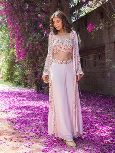 Shop stunning powder pink embroidered crop top with palazzo online in USA and jacket. Dazzle on weddings and special occasions with exquisite Indian designer dresses, sharara suits, Anarkali suits, wedding lehengas from Pure Elegance Indian fashion store in USA.-full view