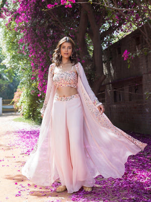 Shop stunning powder pink embroidered crop top with palazzo online in USA and jacket. Dazzle on weddings and special occasions with exquisite Indian designer dresses, sharara suits, Anarkali suits, wedding lehengas from Pure Elegance Indian fashion store in USA.-front
