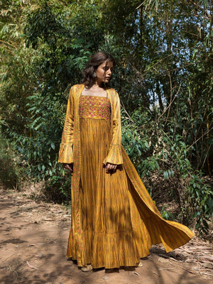 Buy stunning mustard printed maxi dress online in USA with cape jacket. Dazzle on weddings and special occasions with exquisite Indian designer dresses, sharara suits, Anarkali suits, wedding lehengas from Pure Elegance Indian fashion store in USA.-gown
