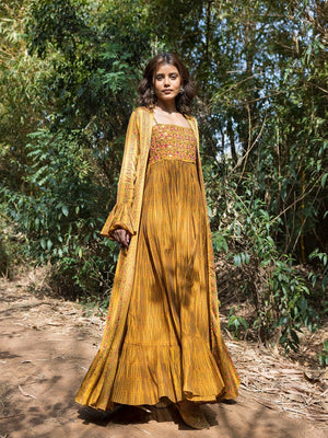 Buy stunning mustard printed maxi dress online in USA with cape jacket. Dazzle on weddings and special occasions with exquisite Indian designer dresses, sharara suits, Anarkali suits, wedding lehengas from Pure Elegance Indian fashion store in USA.-right