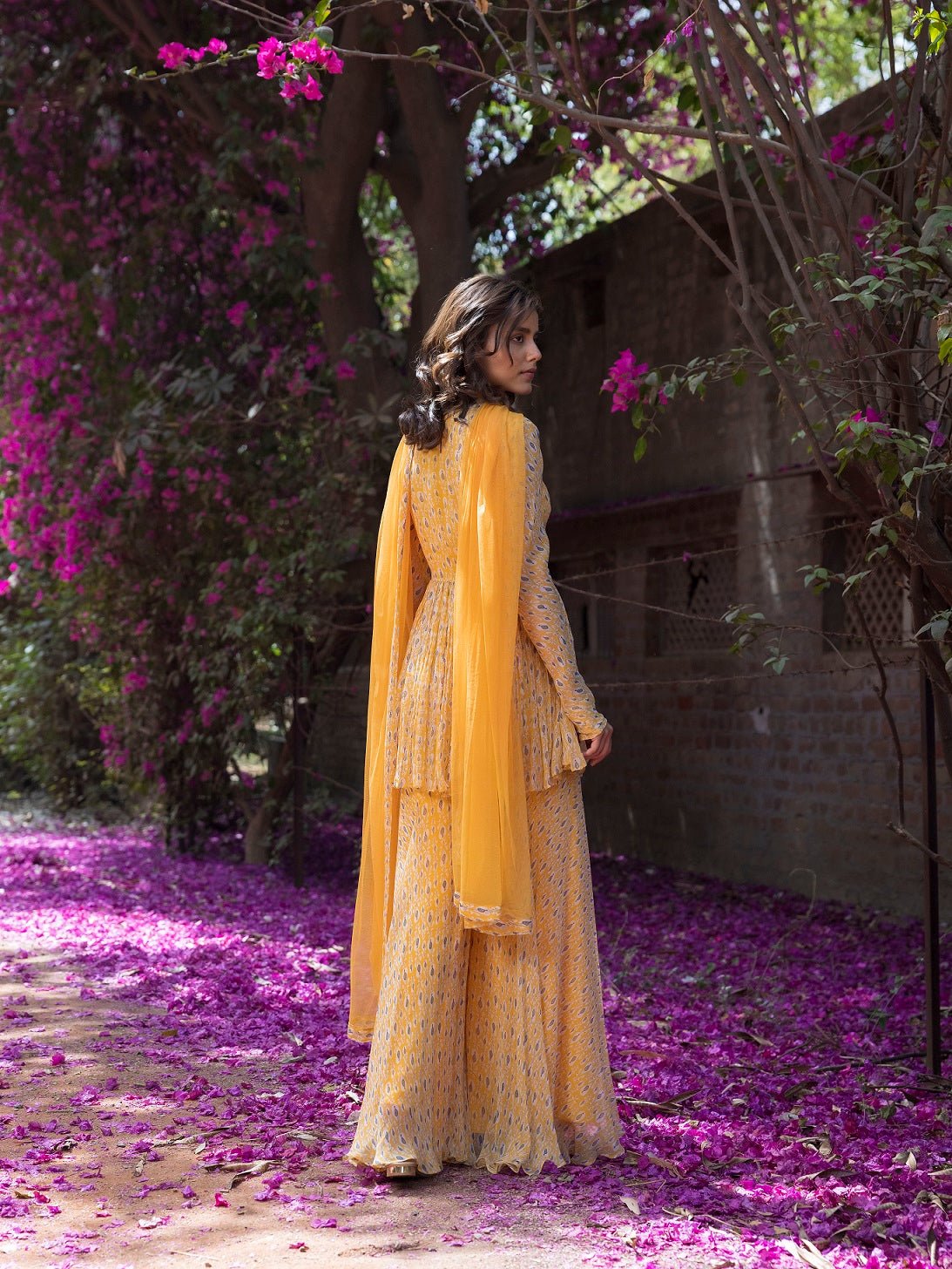 Shop beautiful yellow drop print sharara suit online in USA with embellished front. Dazzle on weddings and special occasions with exquisite Indian designer dresses, sharara suits, Anarkali suits, wedding lehengas from Pure Elegance Indian fashion store in USA.-back
