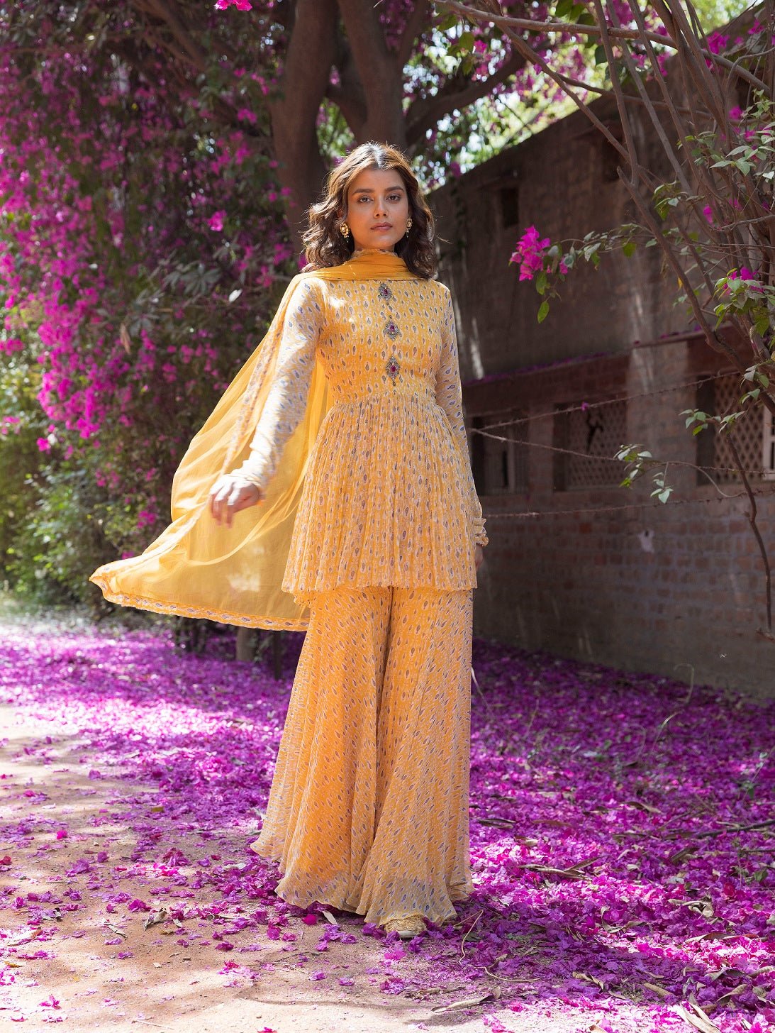 Shop beautiful yellow drop print sharara suit online in USA with embellished front. Dazzle on weddings and special occasions with exquisite Indian designer dresses, sharara suits, Anarkali suits, wedding lehengas from Pure Elegance Indian fashion store in USA.-sharara