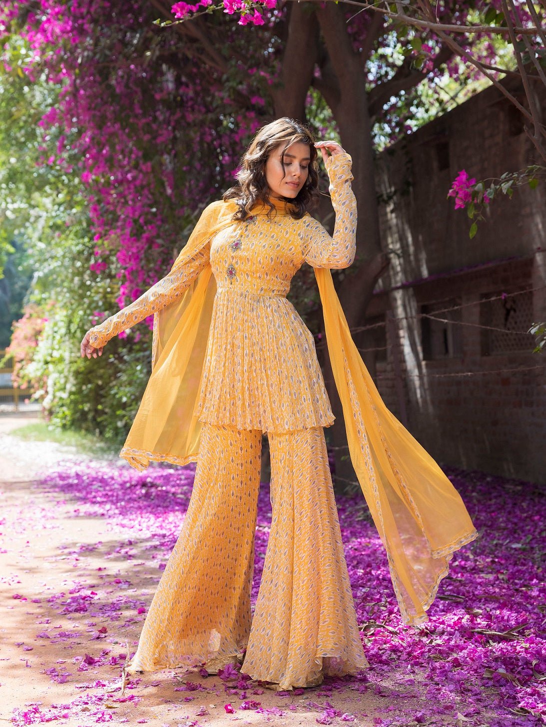Shop beautiful yellow drop print sharara suit online in USA with embellished front. Dazzle on weddings and special occasions with exquisite Indian designer dresses, sharara suits, Anarkali suits, wedding lehengas from Pure Elegance Indian fashion store in USA.-front