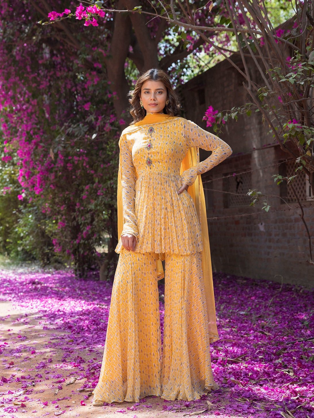 Shop beautiful yellow drop print sharara suit online in USA with embellished front. Dazzle on weddings and special occasions with exquisite Indian designer dresses, sharara suits, Anarkali suits, wedding lehengas from Pure Elegance Indian fashion store in USA.-frontlook