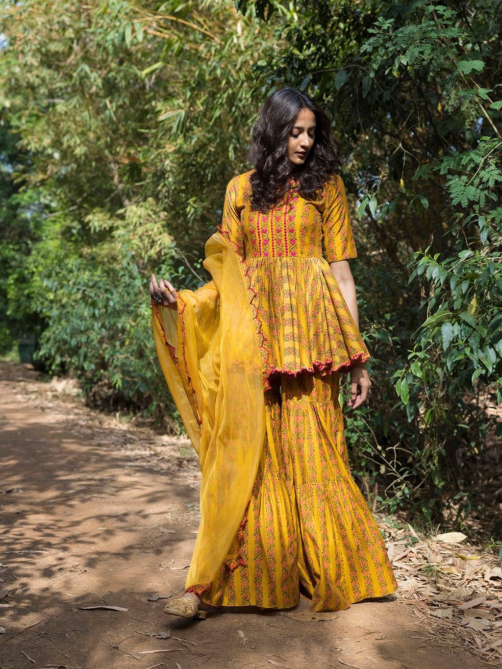 Buy beautiful mustard blossom print sharara suit online in USA. Dazzle on weddings and special occasions with exquisite Indian designer dresses, sharara suits, Anarkali suits, wedding lehengas from Pure Elegance Indian fashion store in USA.-front