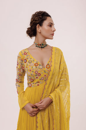 Buy this Look your best on festive occasions in this beautiful yellow georgette suit with a floral peplum top and pleated sharara with multicolor pearl. It comes with a matching organza dupatta. Dazzle on weddings and special occasions with exquisite Indian designer dresses, sharara suits, Anarkali suits, and wedding lehengas from Pure Elegance Indian fashion store in the USA.