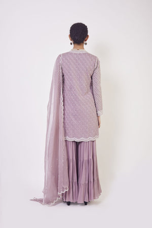 Shop lilac resham and cutdana work gharara suit in USA with dupatta. Dazzle on weddings and special occasions with exquisite Indian designer dresses, sharara suits, Anarkali suits, wedding lehengas from Pure Elegance Indian fashion store in USA.-back